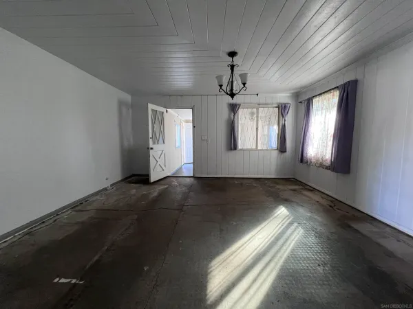 a view of dirt yard with large trees