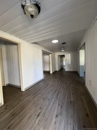 a view of a livingroom from a hallway