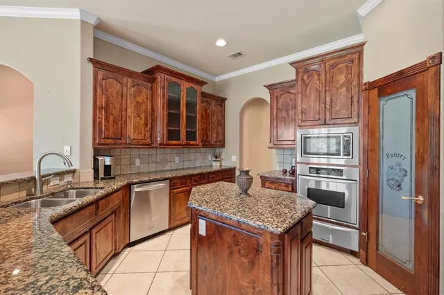 a kitchen with a sink stove and refrigerator