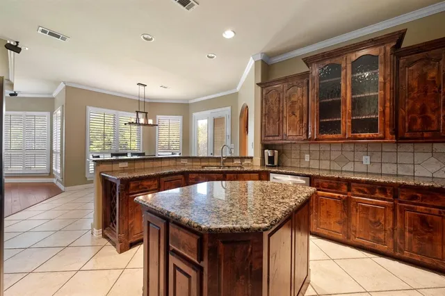 a kitchen with granite countertop a sink and cabinets