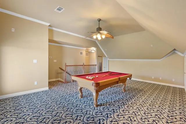 a room with pool table and wooden floor