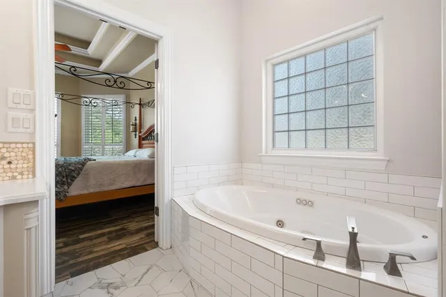 a bathroom with a tub and a shower