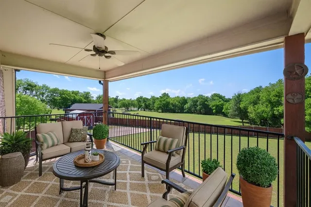 a view of a balcony with furniture and a floor to ceiling window