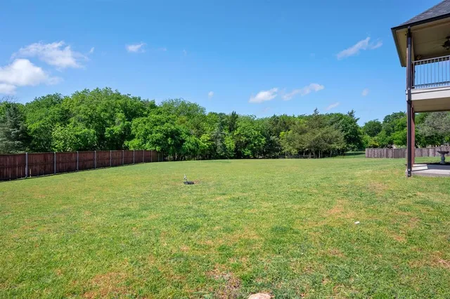a view of a yard with a trampoline
