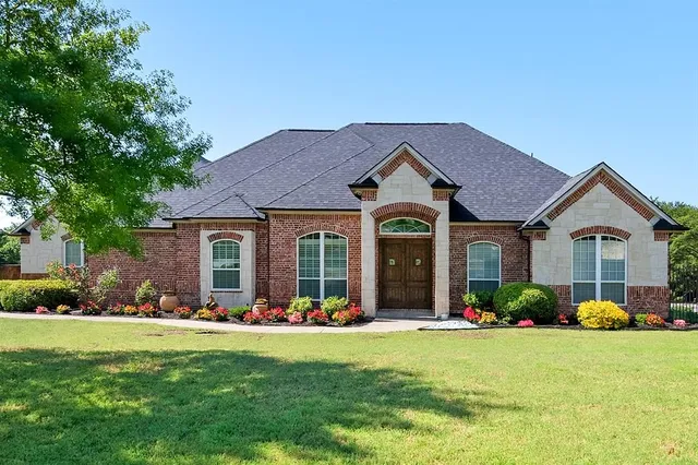 a front view of a house with garden