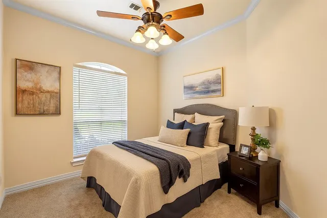 a bedroom with a bed and a painting on the wall