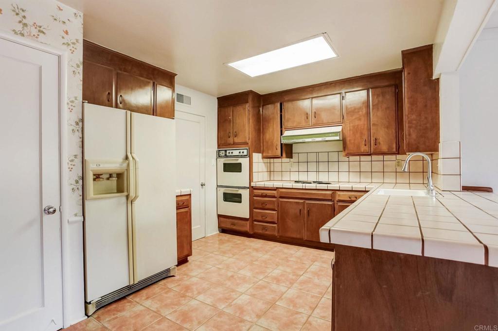 45 Springer Road Los Altos, CA 94024 - Photo 12 of 33 a kitchen with stainless steel appliances kitchen island granite countertop a refrigerator and a stove top oven