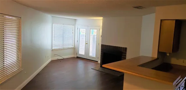 a view of a kitchen with wooden floor and a window