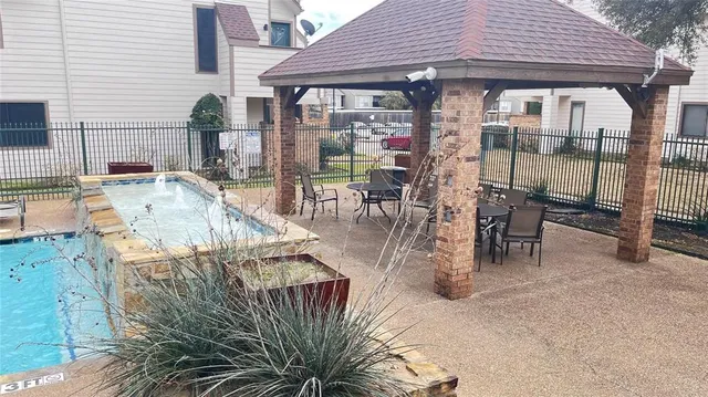 a view of a patio with table and chairs and potted plants