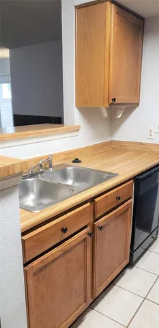 a kitchen with granite countertop cabinets stainless steel appliances and a sink