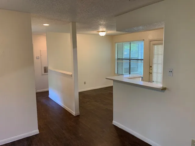 an empty room with windows and entrance