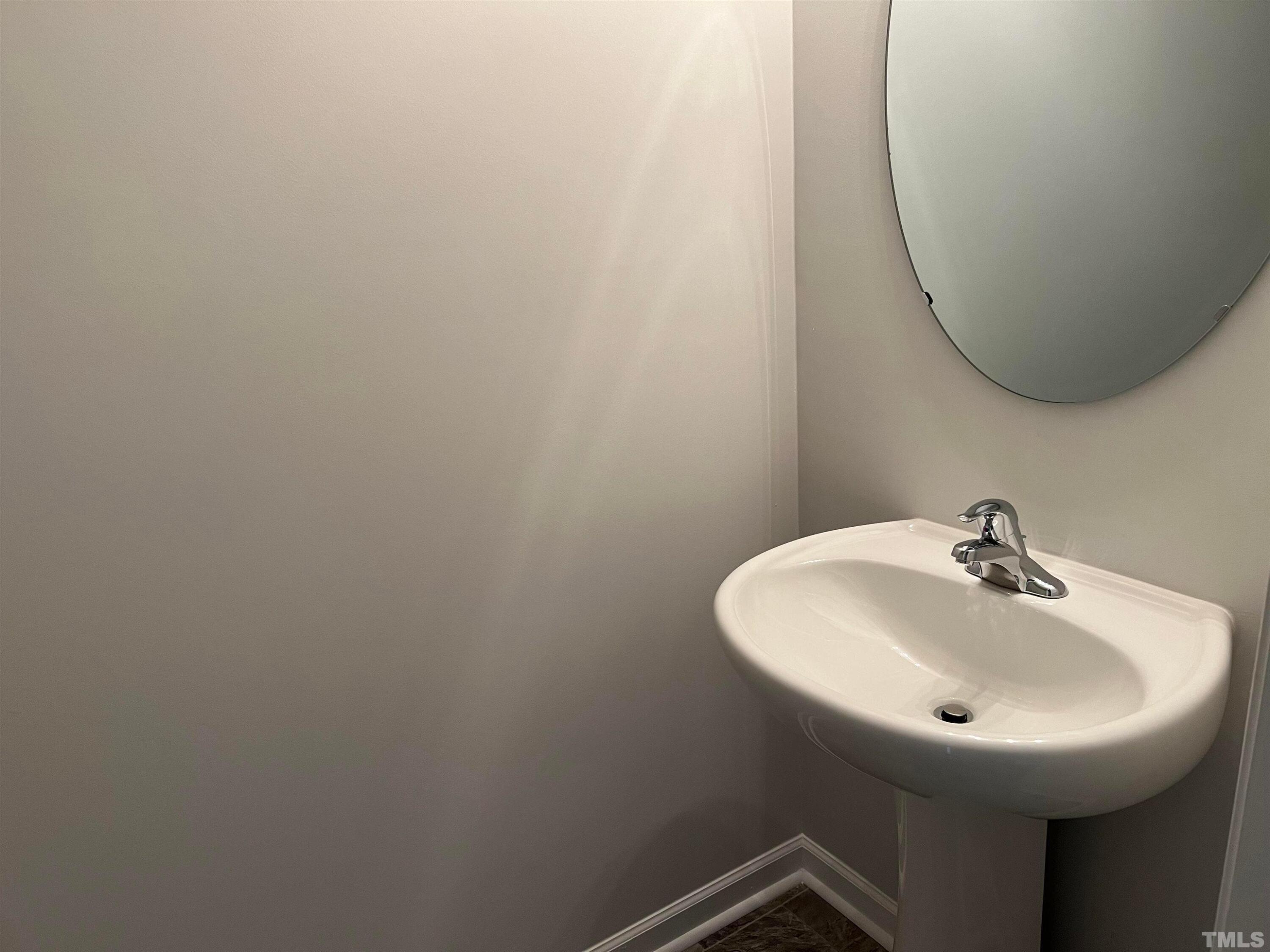 179 Maple Tree Lane Clayton, NC 27527 - Photo 7 of 18 a bathroom with a sink and mirror