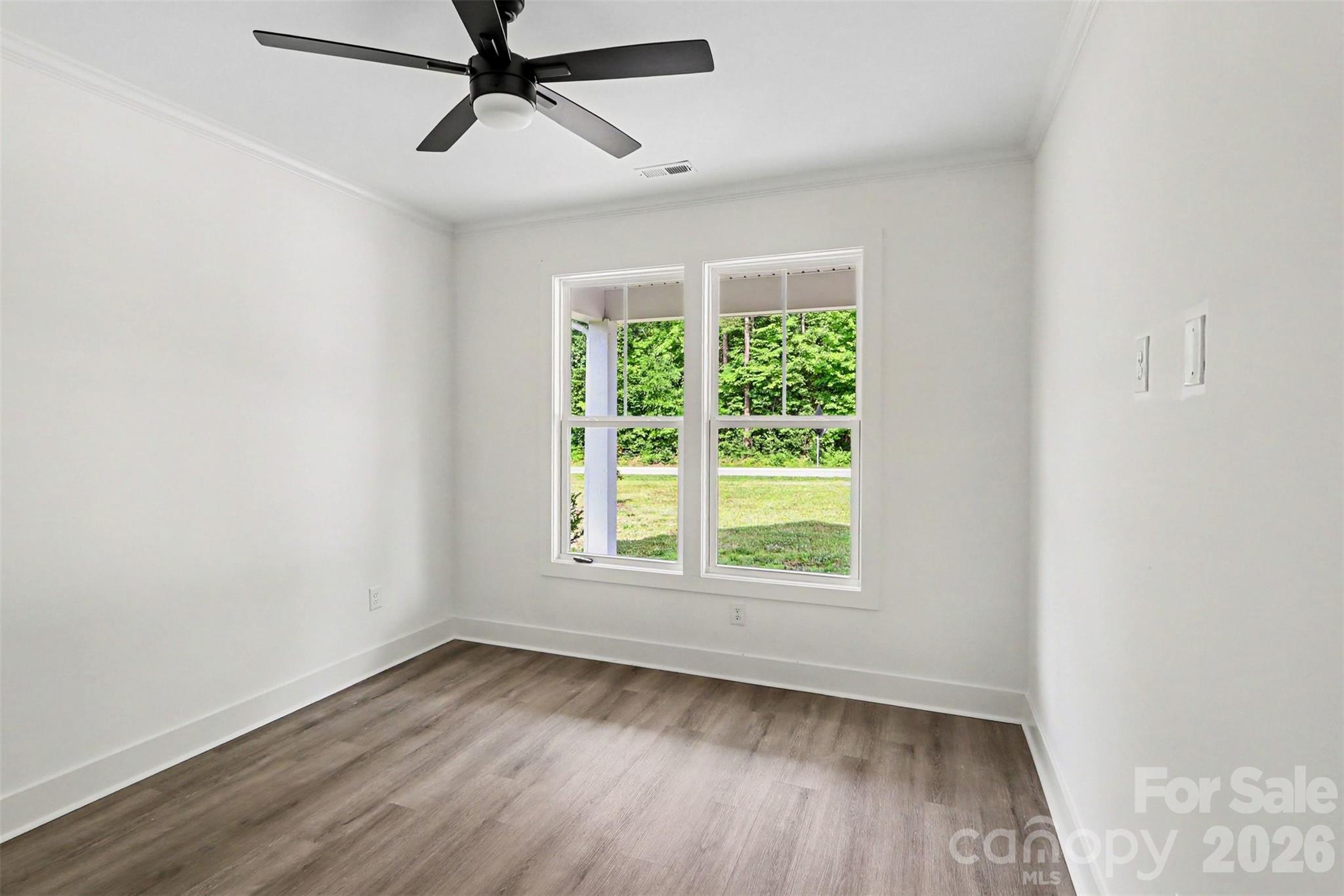 4115 Miller Road Salisbury, NC 28147 - Photo 22 of 26 an empty room with a window and a ceiling fan