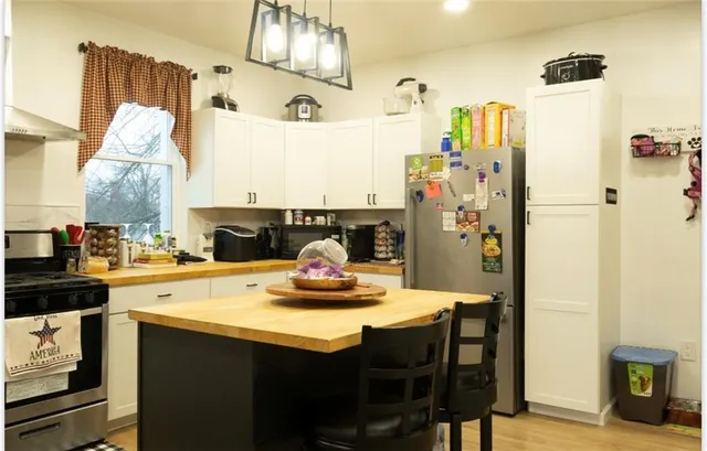 a kitchen with refrigerator and cabinets