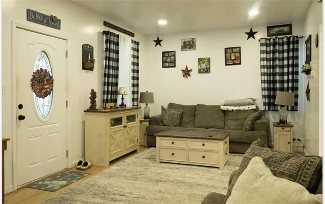 a living room with furniture and white walls