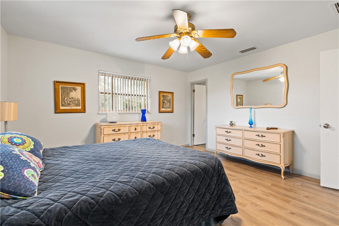 618 Conn Way Vero Beach, FL 32963 - Photo 16 of 36 a bedroom with a bed and a chandelier