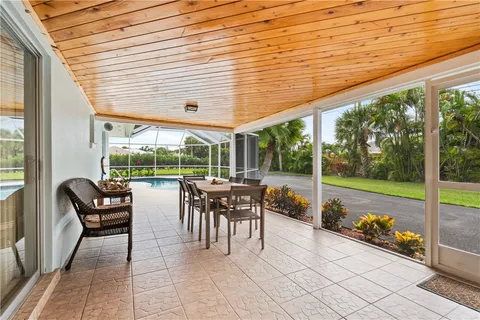 a view of a patio with dining table and chairs