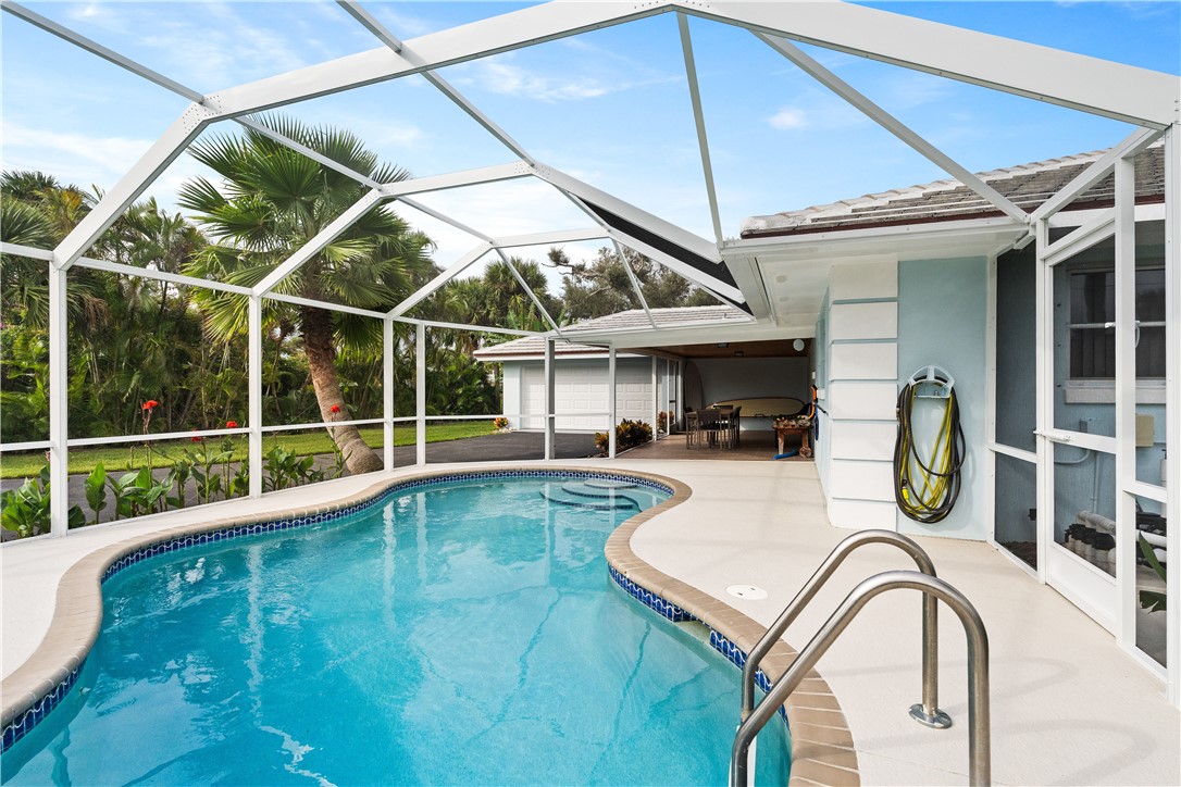 618 Conn Way Vero Beach, FL 32963 - Photo 24 of 36 a view of a swimming pool with a patio and a yard