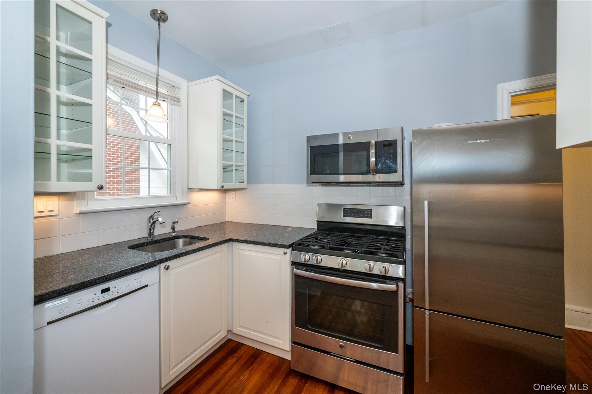 82 Clove Road New Rochelle, NY 10801 - Photo 11 of 39 a kitchen with granite countertop stainless steel appliances a sink stove and refrigerator