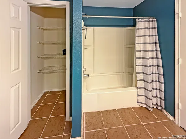 a bathroom with a glass shower door