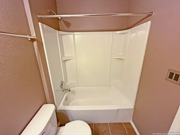 a bathroom with a shower curtain and a bath tub