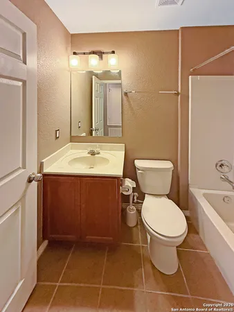a bathroom with a sink toilet vanity and shower