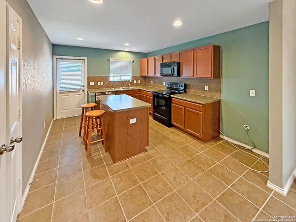 a kitchen with stainless steel appliances granite countertop a sink and cabinets