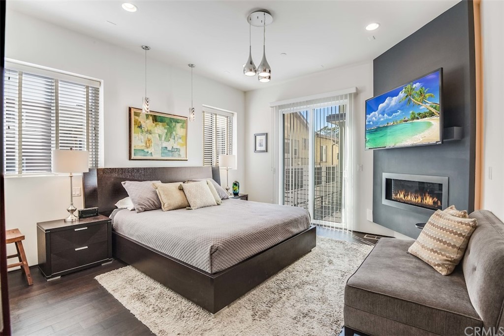 203 South Prospect Avenue, Unit A Redondo Beach, CA 90277 - Photo 18 of 39 a spacious bedroom with a bed a couch and a flat screen tv