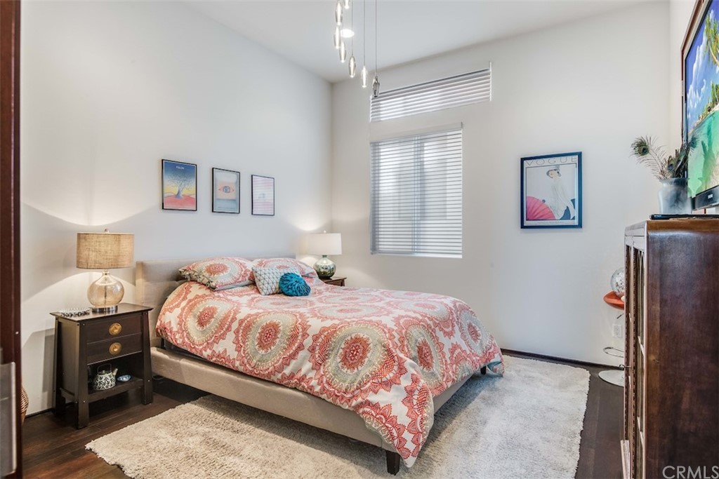 203 South Prospect Avenue, Unit A Redondo Beach, CA 90277 - Photo 23 of 39 a bedroom with a bed wooden floor and window