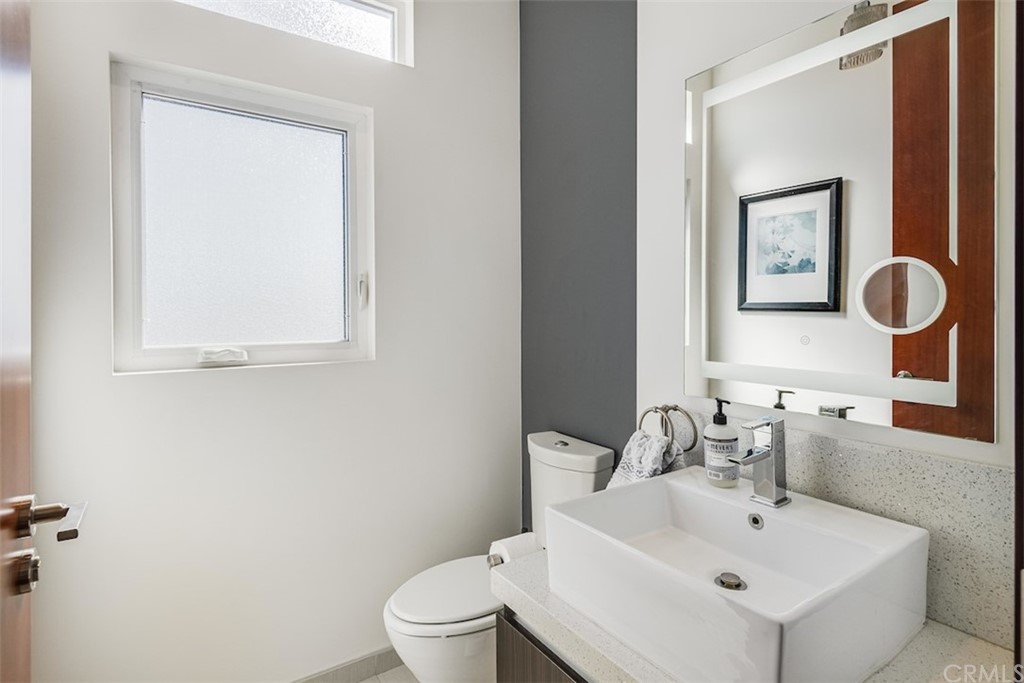 203 South Prospect Avenue, Unit A Redondo Beach, CA 90277 - Photo 24 of 39 a bathroom with a toilet sink and mirror