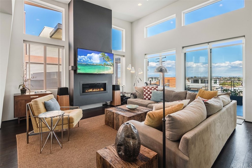 203 South Prospect Avenue, Unit A Redondo Beach, CA 90277 - Photo 9 of 39 a living room with furniture a fireplace and a large window