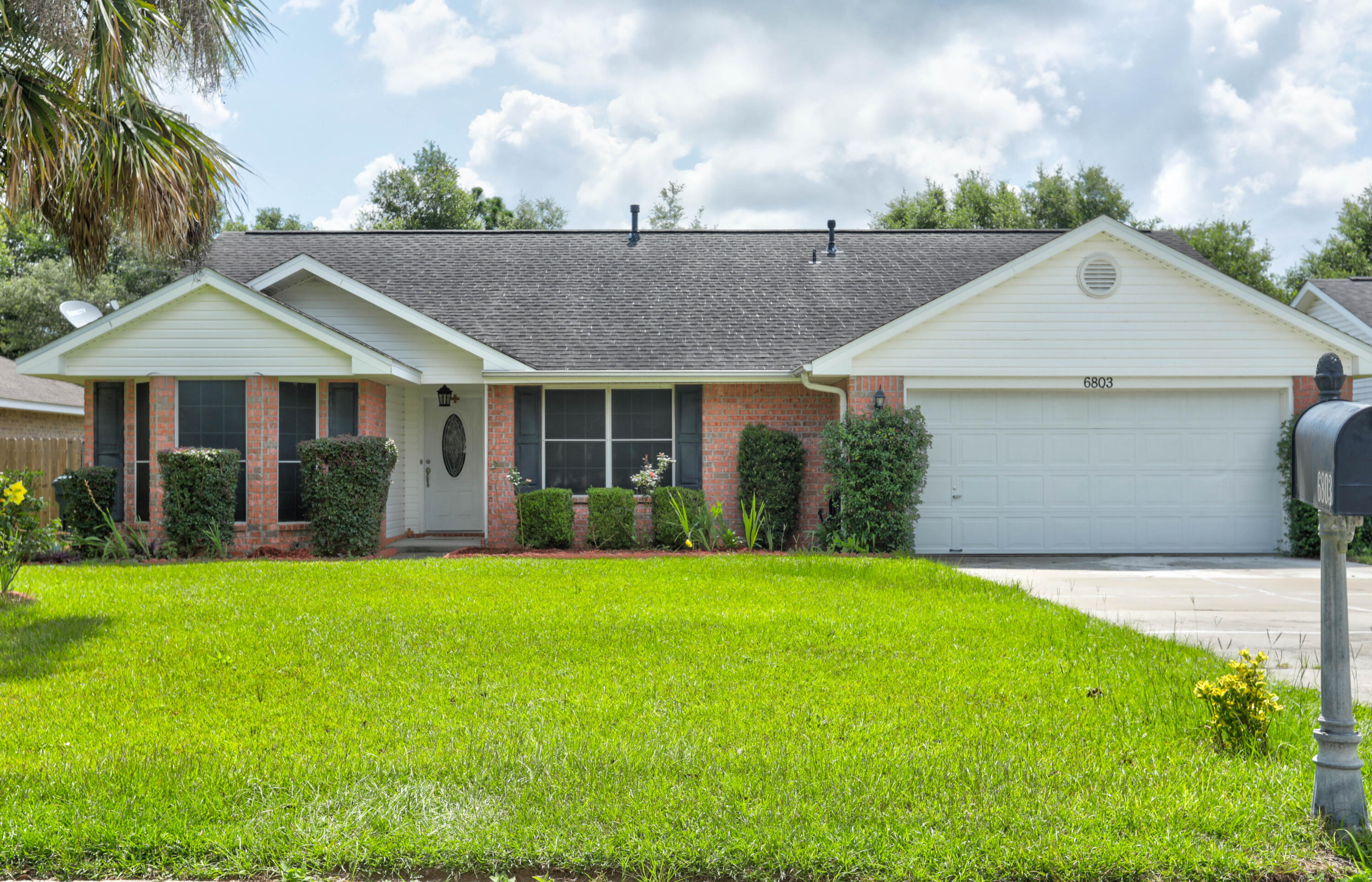 6803 Cedar Ridge Circle Milton, FL 32570 - Photo 1 of 26 a front view of a house with a yard and garage