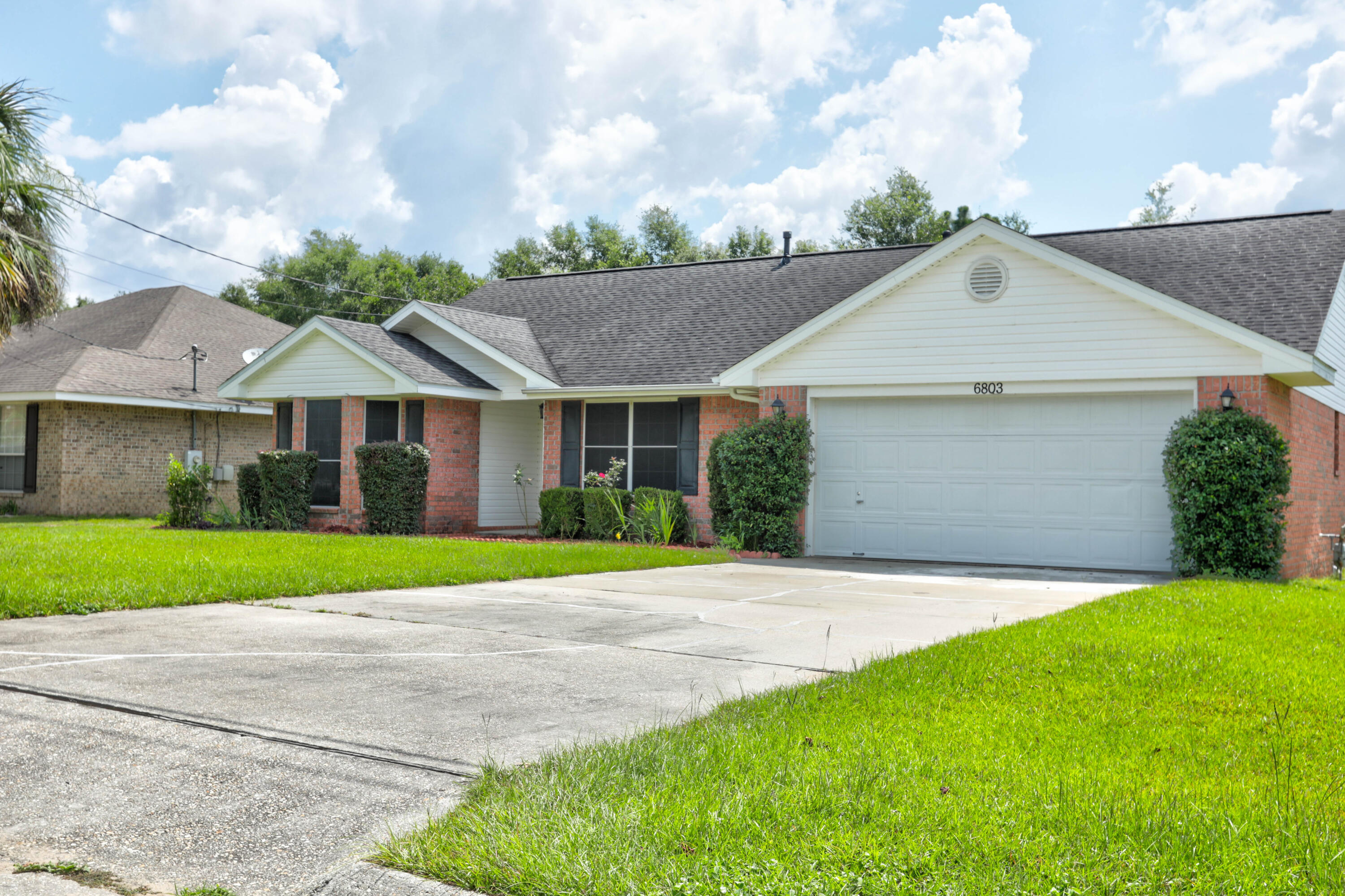 6803 Cedar Ridge Circle Milton, FL 32570 - Photo 2 of 26 a front view of a house with a yard and garage