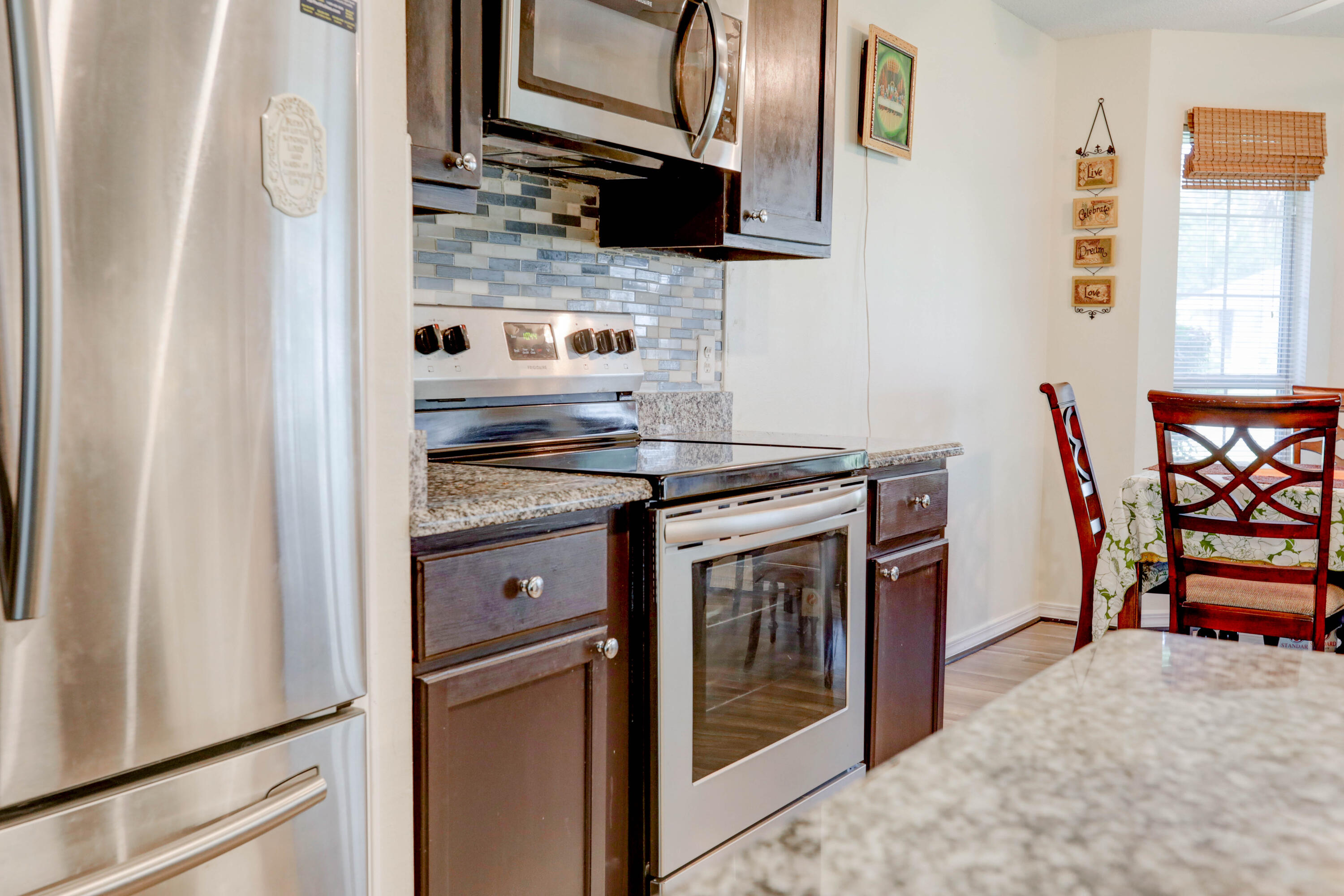 6803 Cedar Ridge Circle Milton, FL 32570 - Photo 16 of 26 a kitchen with stainless steel appliances granite countertop a stove and a refrigerator