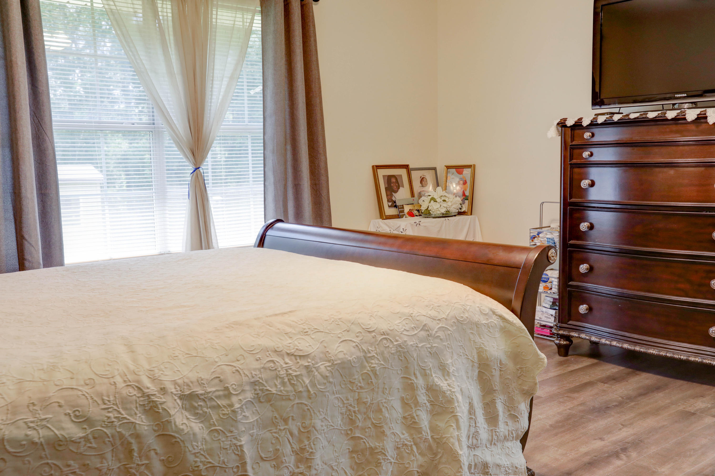 6803 Cedar Ridge Circle Milton, FL 32570 - Photo 22 of 26 a bedroom with a bed window and flat screen tv