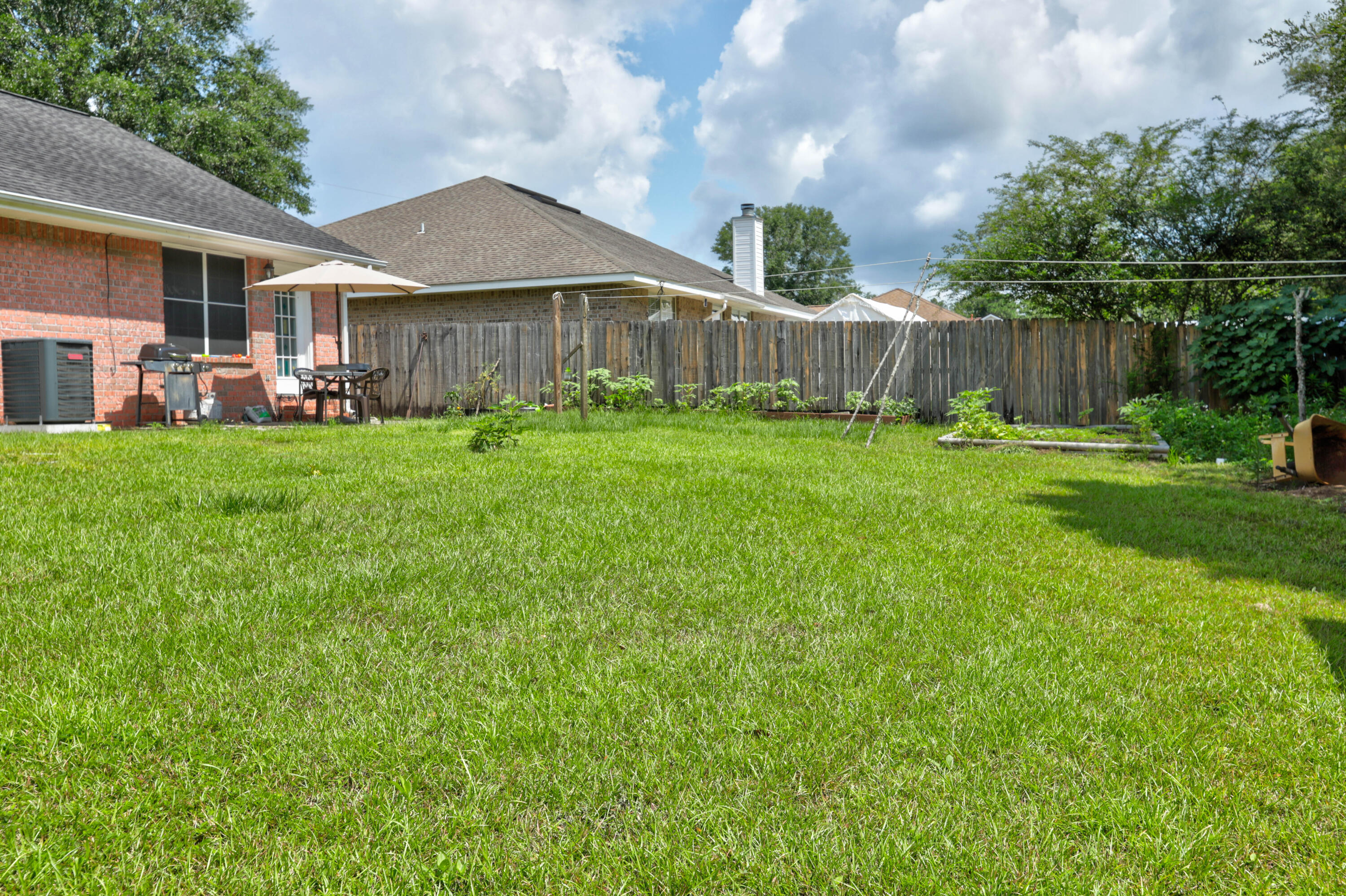 6803 Cedar Ridge Circle Milton, FL 32570 - Photo 6 of 26 a front view of a house with yard and green space
