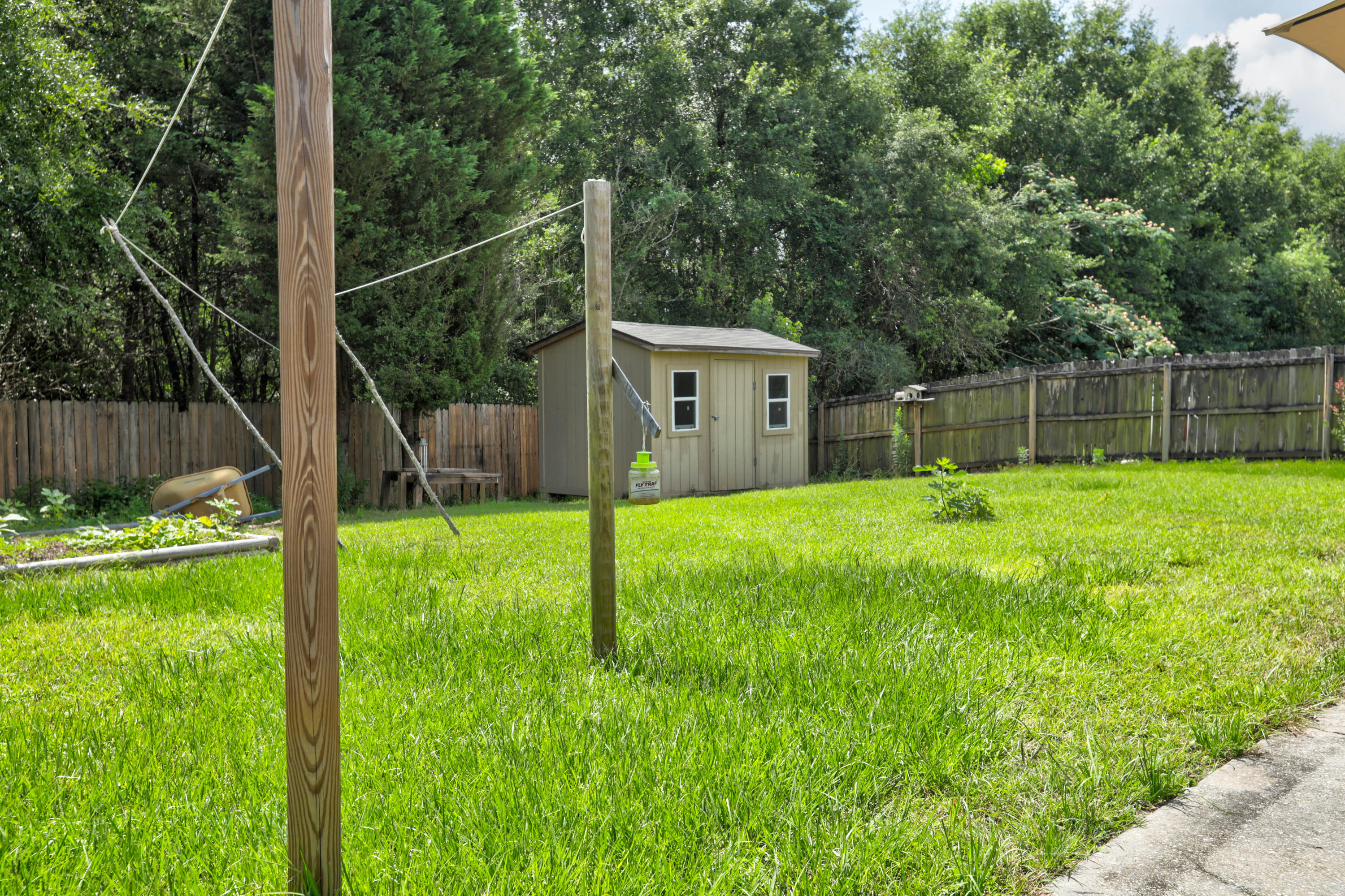 6803 Cedar Ridge Circle Milton, FL 32570 - Photo 9 of 26 a view of a backyard with a small cabin