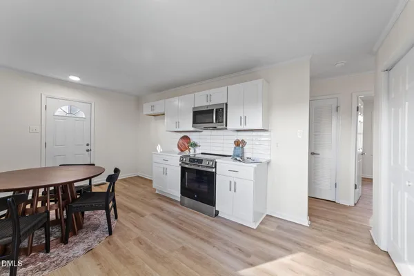 a kitchen with stainless steel appliances kitchen island granite countertop a stove a sink and a refrigerator