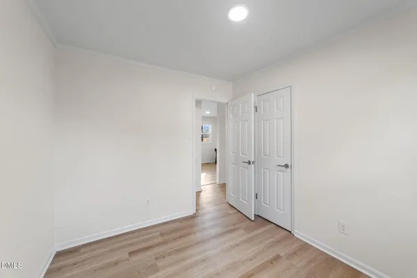 a view of an empty room and wooden floor