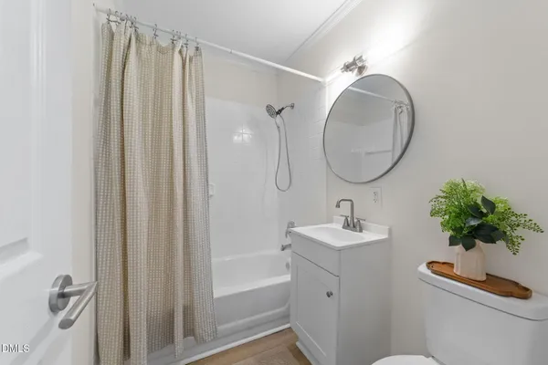 a bathroom with a sink a mirror a vanity and a shower