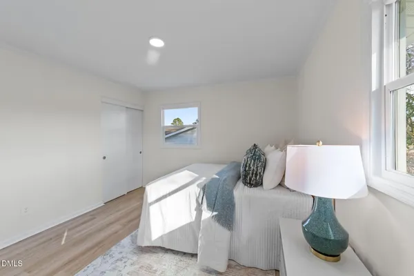 a bedroom with a bed and a lamp