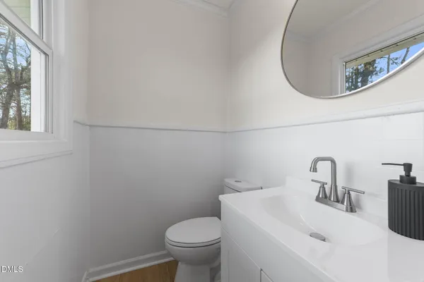 a bathroom with a sink mirror and toilet