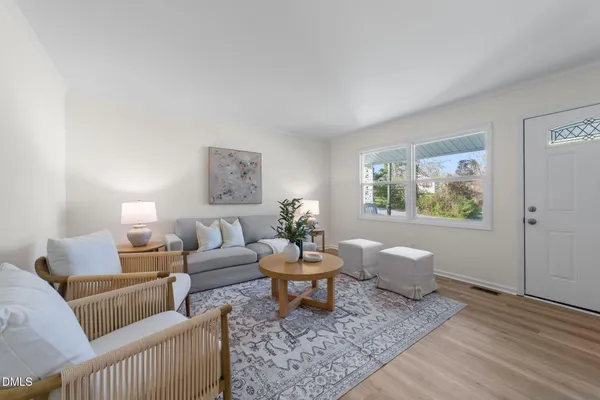 a living room with furniture and wooden floor