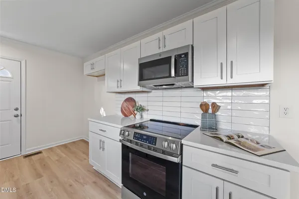 a kitchen with a stove and a microwave