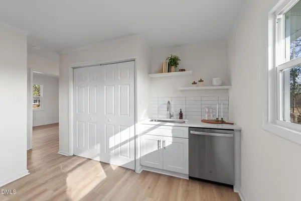 a kitchen with stainless steel appliances a sink stove and cabinets