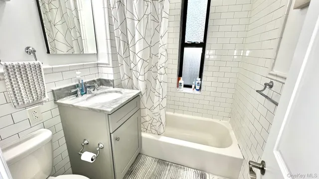 a bathroom with a sink a toilet and a bathtub