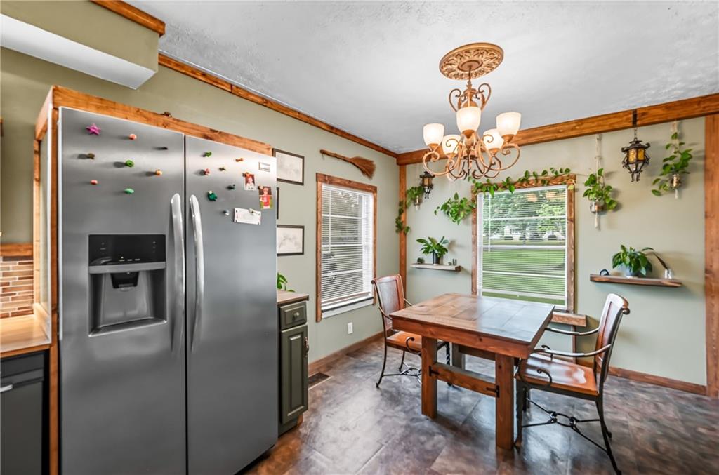 3575 Morefield Road Hermitage, PA 16148 - Photo 12 of 39 a dining room with furniture a chandelier and wooden floor