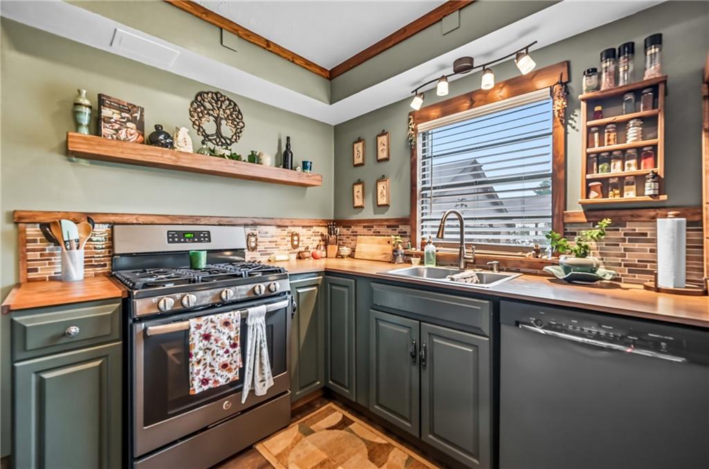 3575 Morefield Road Hermitage, PA 16148 - Photo 15 of 39 a kitchen with stainless steel appliances granite countertop a stove and a sink