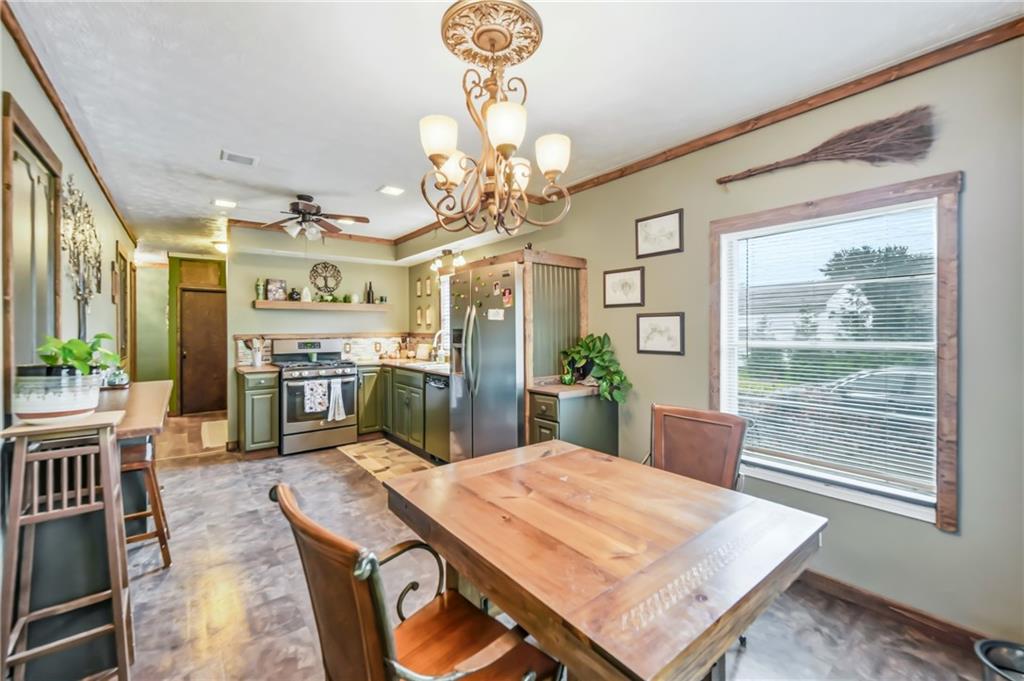 3575 Morefield Road Hermitage, PA 16148 - Photo 21 of 39 a view of a dining room with furniture a chandelier and wooden floor