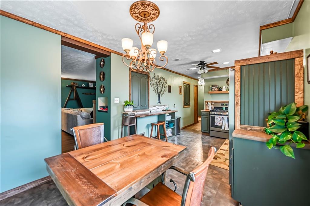 3575 Morefield Road Hermitage, PA 16148 - Photo 22 of 39 a dining room with furniture a chandelier and wooden floor